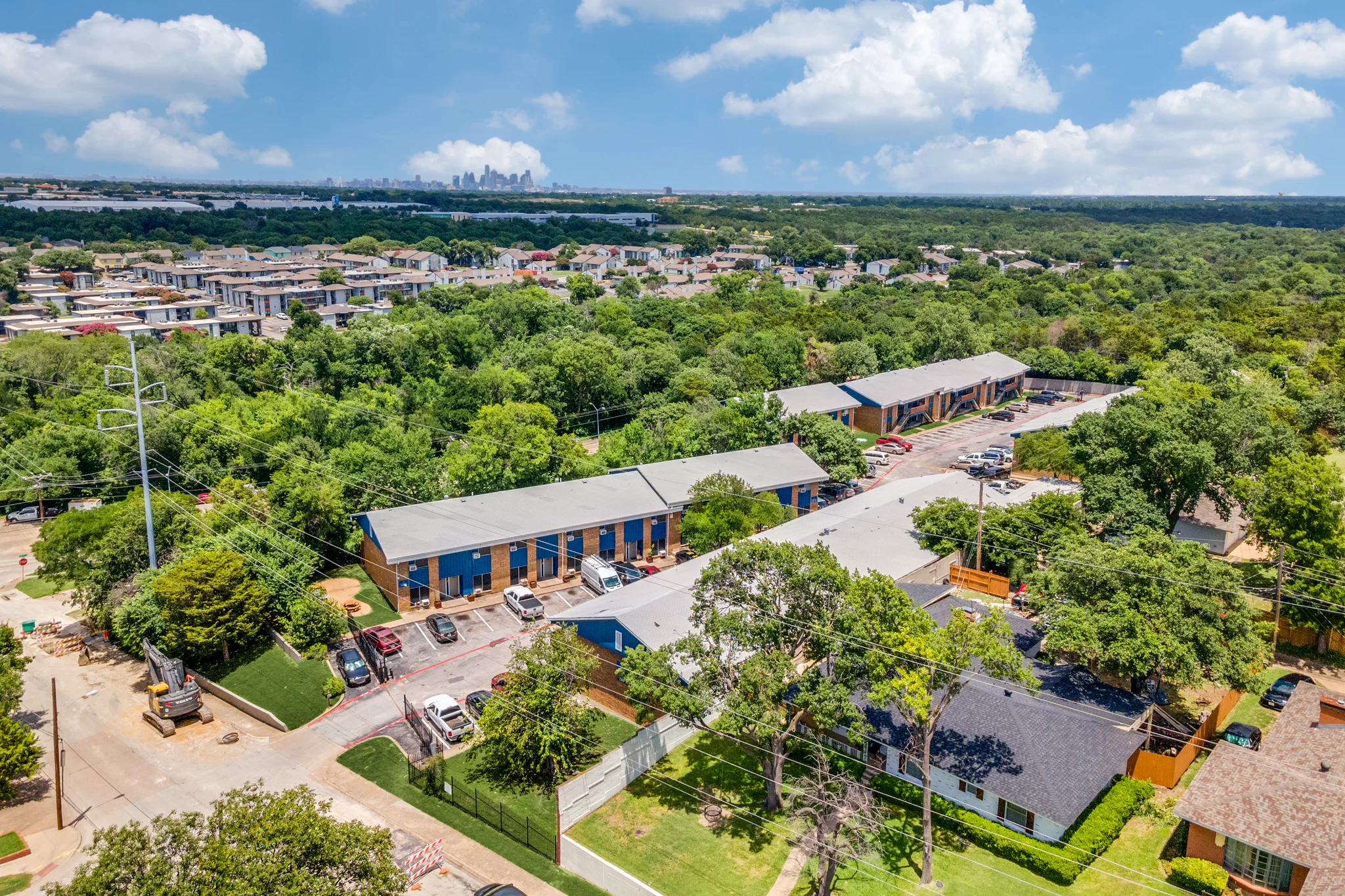 A wide view from the air, the property in its tree canopy with the horizon beyond.