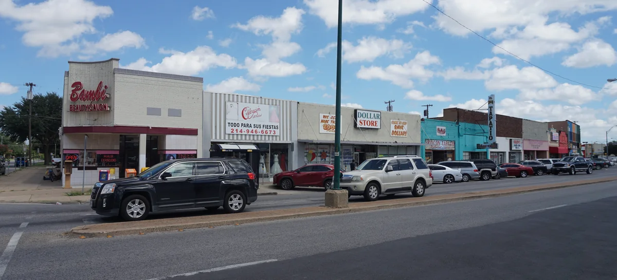 A row of storefronts and signage along Jefferson Boulevard in Oak Cliff.