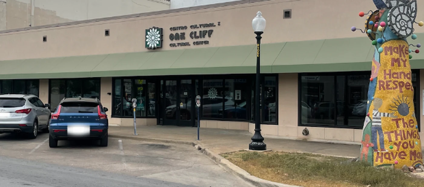 The Oak Cliff Cultural Center storefront on Jefferson Boulevard, a mosaic sculpture beside it.